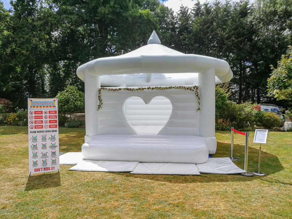 White bouncy castle set up for a wedding