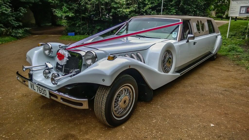 Pearl White Lincoln Excalibur Stretch Limo decorated for a wedding day